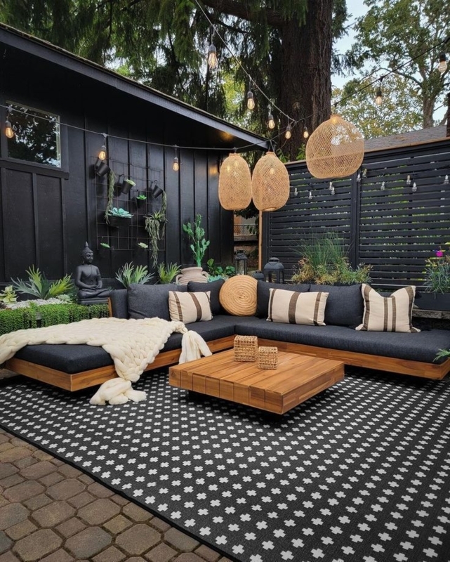 Contemporary Black Pergola Frame Over an Outdoor Fireplace Lounge