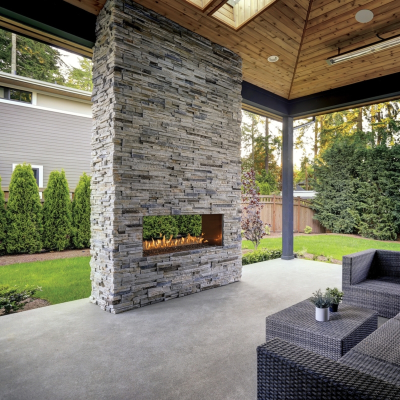 Contemporary Garden Wall Fireplace Recessed into Dark Stone Surround