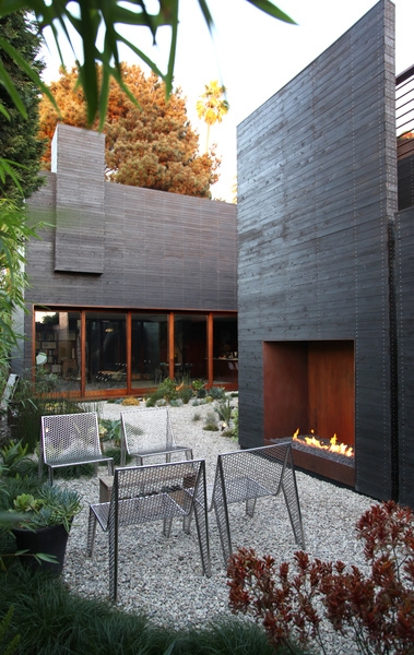 Contemporary Outdoor Fireplace with Tall Metal Chimney Stack on Deck