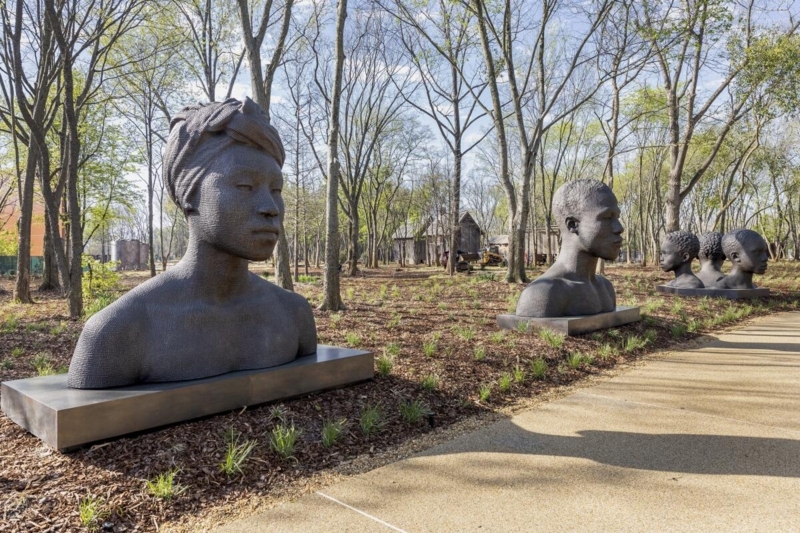 Contemporary Outdoor Sculpture with Humanoid Form and Stylized Faces.