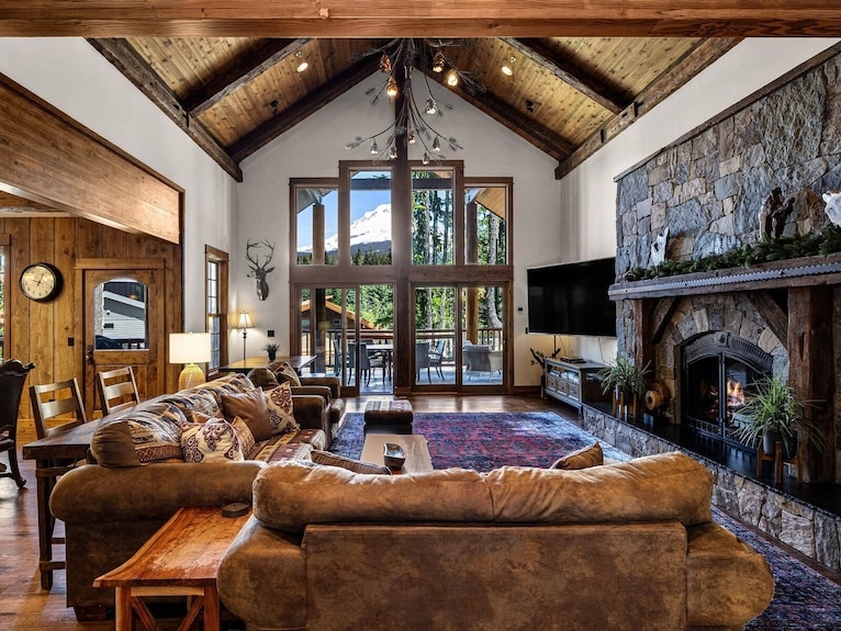 Cozy Cabin Living Room with Floor-to-Ceiling Windows and Forest Views
