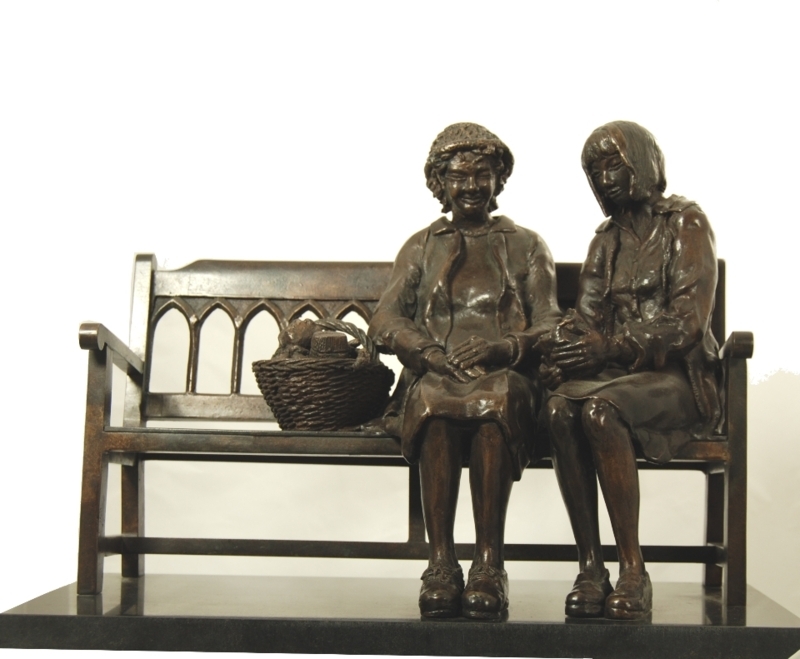 Dark Metallic Sculpture with Interconnected Ring of Figures.