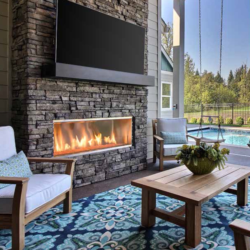 Dramatic Linear Outdoor Fireplace with Blue Flames in Stacked Stone