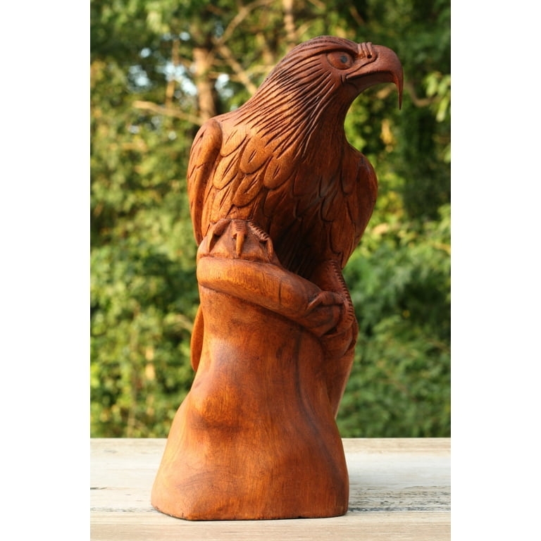 Eagle Statue with spread wings and hand carved details in dark brown.