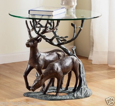 End Table with sculptural base, deer motif, and round glass top.