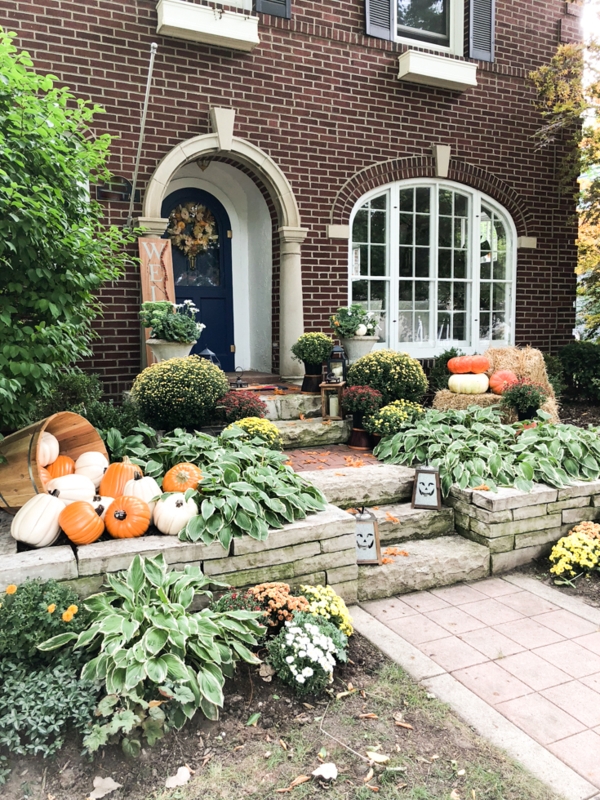 Farmhouse Porch Entry with Layered Rug Base and Bold Black Door
