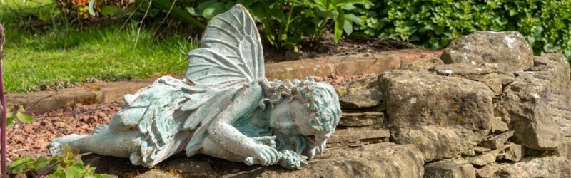 Garden Statue Seated Angel Silhouette with Pitted Surface