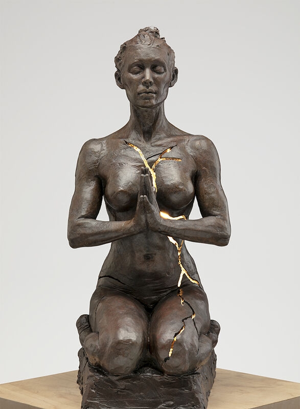Glowing Meditative Bronze Sculpture Internal Lighting High Contrast Art