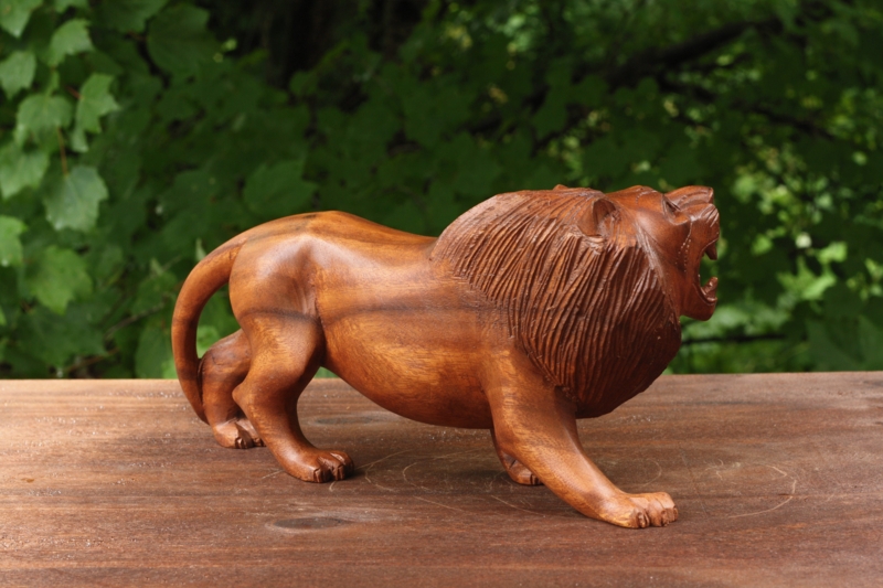 Hand Carved Lion Statue with stylized mane in reddish brown wood.