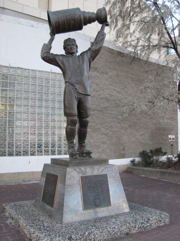 Hockey Player Sculpture Hoisting Championship Trophy