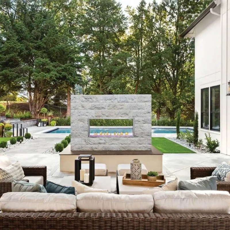 Linear Outdoor Fireplace with Stainless Steel Trim and Amber Glass