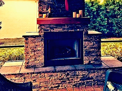 Matte Black Outdoor Fireplace, Built-In Log Storage Niche, Modern Design.