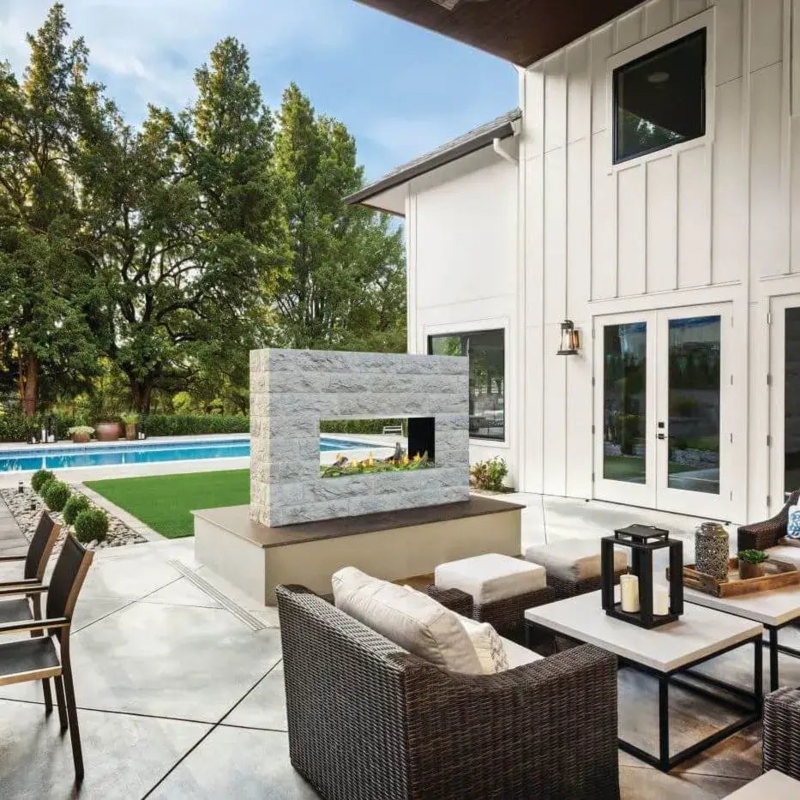 Modern Linear Outdoor Fireplace with Blue Glass Media and Stone Wall