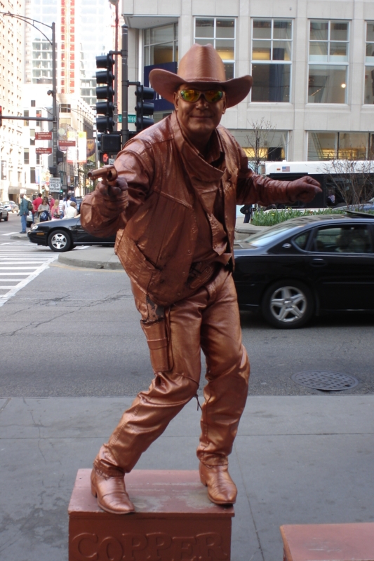Monochromatic Metallic Sculpture with Western Silhouette and Cowboy Hat.
