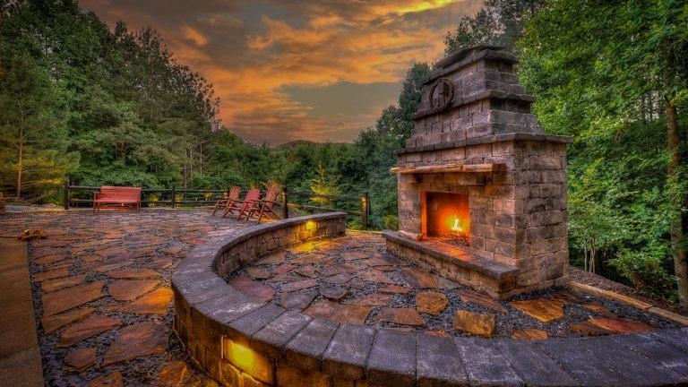 Mountain Cabin Deck with Circular Fire Pit and Adirondack Chairs