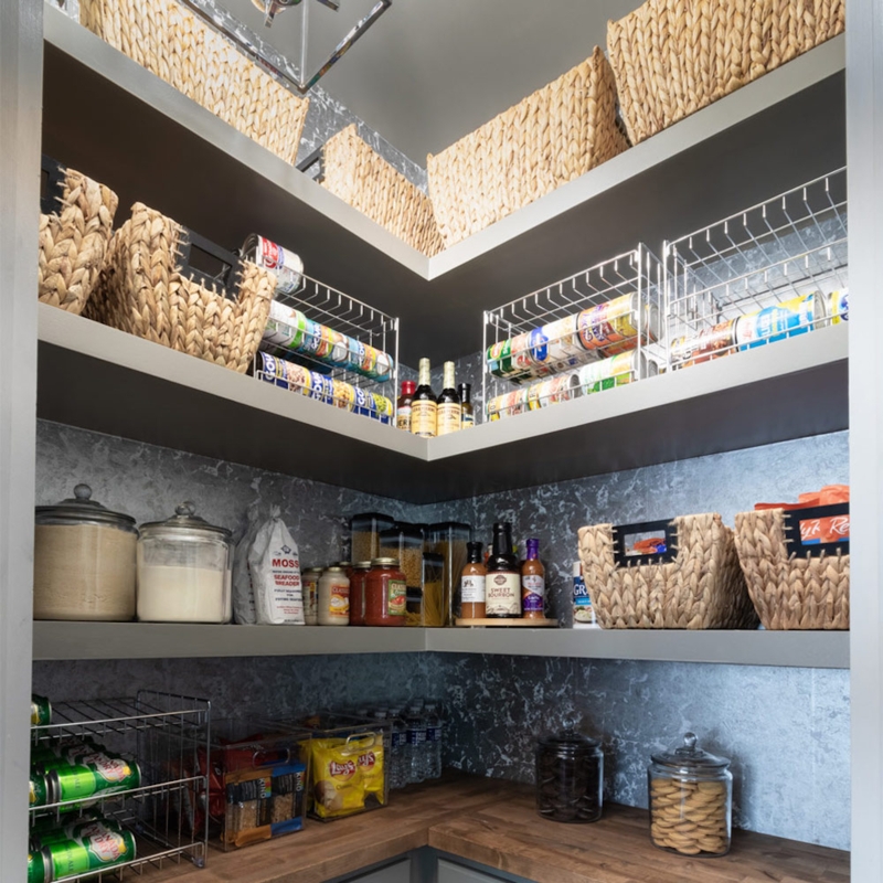 Navy Pantry System with Botanical Wallpaper and Brass Accents