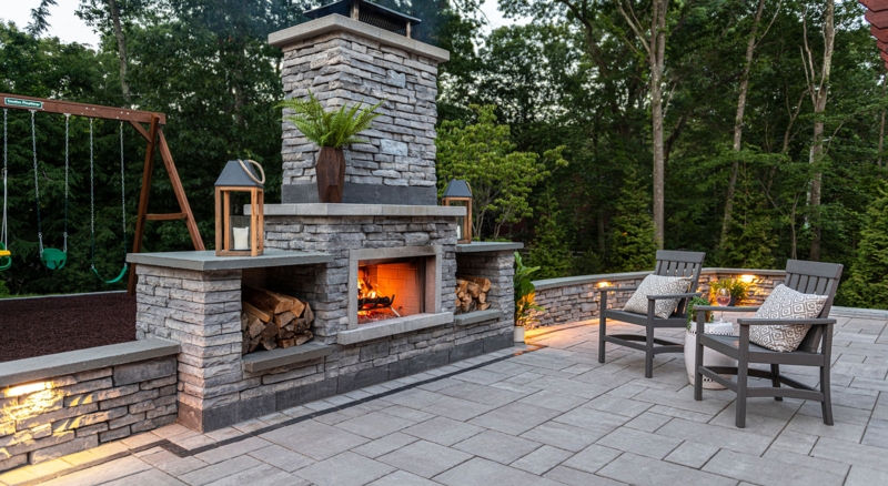 Outdoor Fireplace Integrated Wood Niches. Modern stone paver patio ideas.