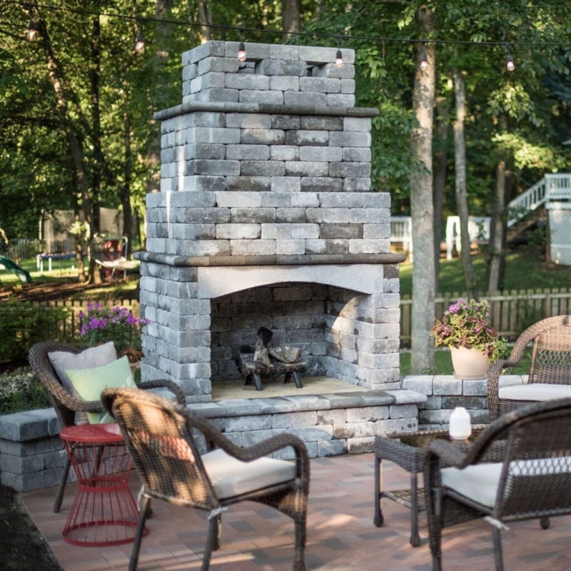 Outdoor Fireplace Rustic Stone Masonry with Tiered Hearth and Log Storage