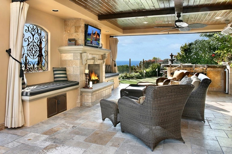 Outdoor Fireplace Stone Clad with Sectional and String Lights