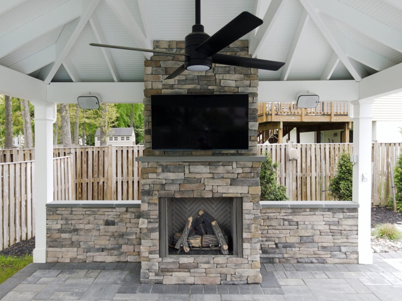 Outdoor Fireplace Stone Veneer with Mounted TV and Wood Mantel for Patio