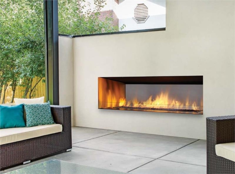Outdoor Fireplace Wide Profile Linear Design on Stacked Stone Wall.