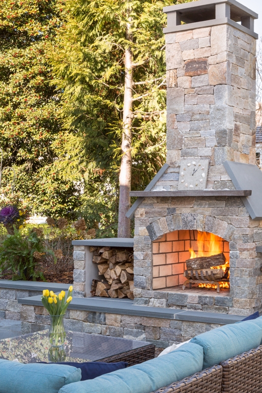 Outdoor Fireplace with Extended Side Hearths and Tiered Chimney