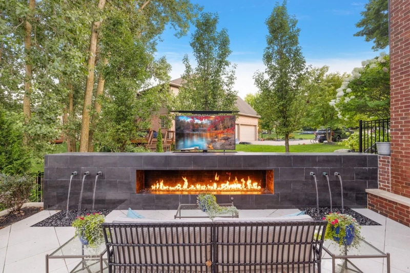 Outdoor Fireplace with Integrated TV and Stacked Stone Facade