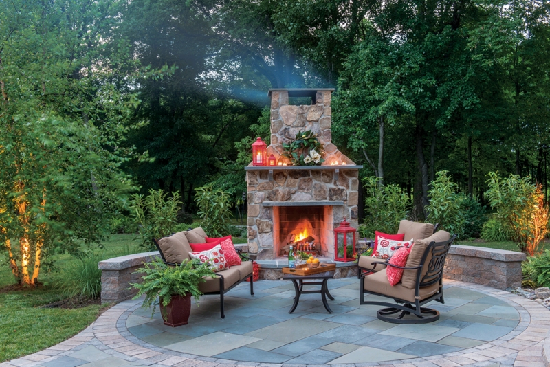 Outdoor Fireplace with Timber Pergola and Wicker Seating Arrangement