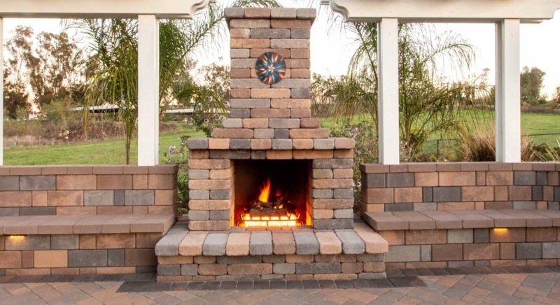 Outdoor Fireplace with Tumbled Masonry Finish and Log Storage