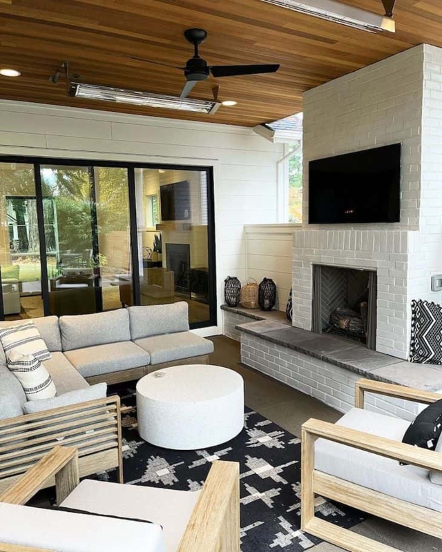 Outdoor Fireplace with Wicker Seating and Stone Masonry Design