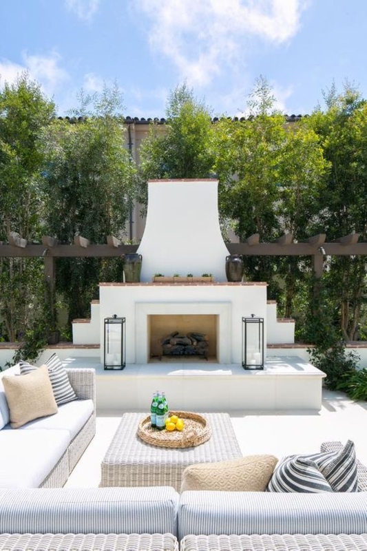 Outdoor Sofa White Stucco Fireplace, White Wicker. Coastal Style.