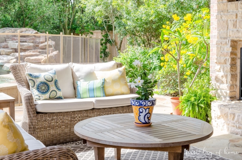 Patio Sectional Sofa with Warm Wood Frame and Blue Patterned Pillows