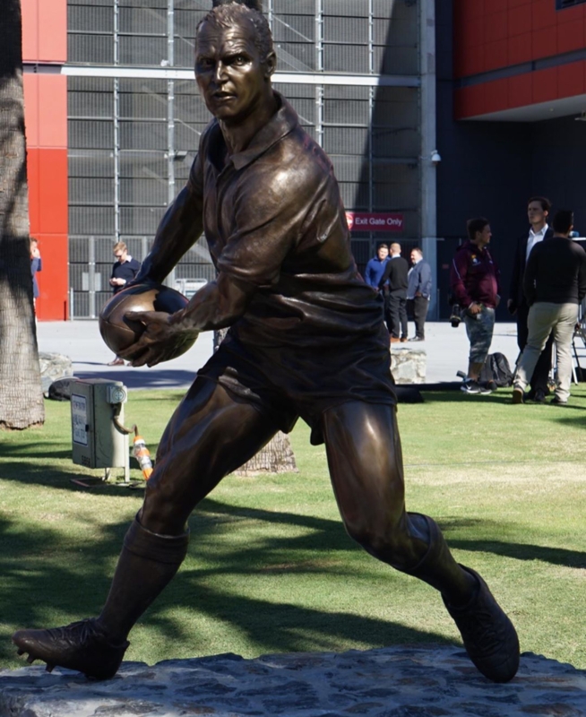 Rugby Player Sculpture with Muscular Definition on Base