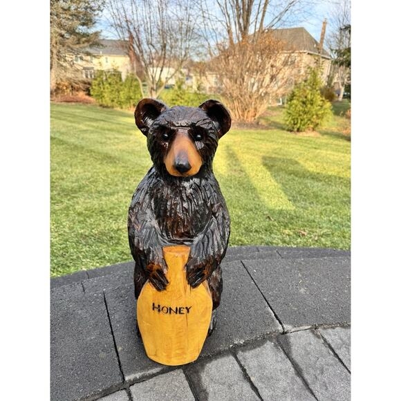 Rustic Bear Statue with chainsaw carved texture holding a honey pot.