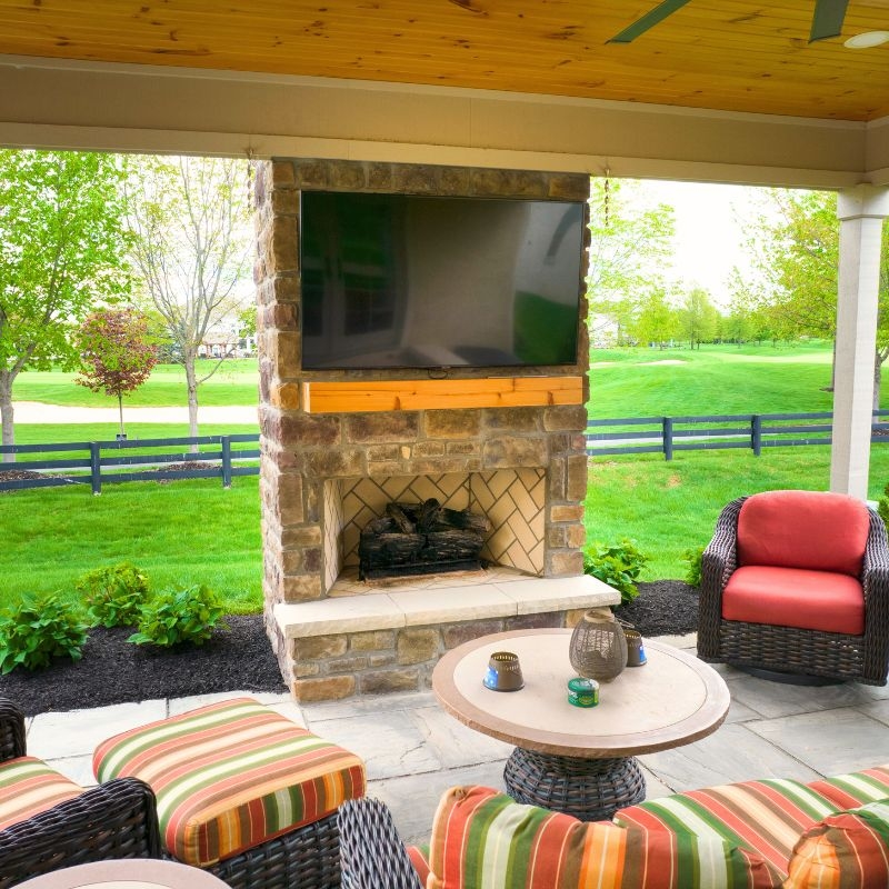 Rustic Outdoor Fireplace with Integrated Log Storage and Stacked Stone