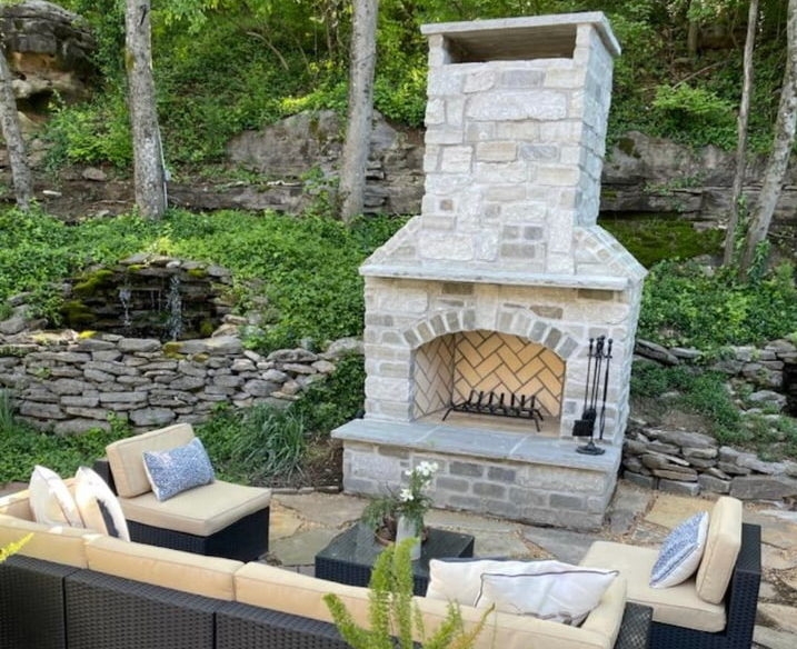 Rustic Outdoor Fireplace with Stacked Stone Veneer and Wood Mantel