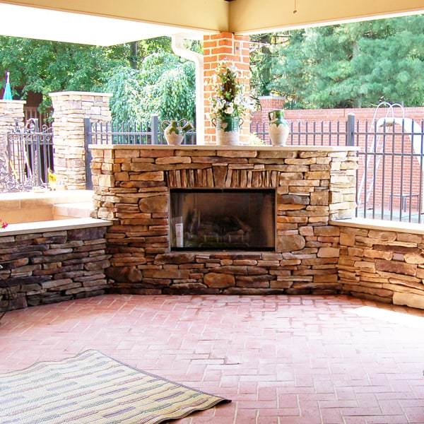Rustic Outdoor Stone Fireplace with Built-In Log Storage