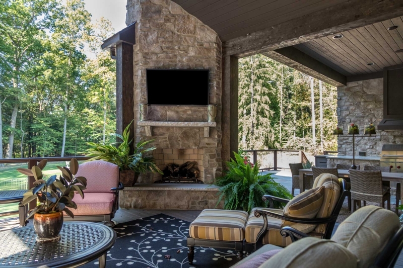 Rustic Stone Veneer Outdoor Fireplace with Arched Wood Storage Niches