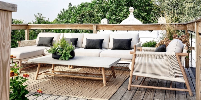 Sectional Sofa featuring Slatted Wood Frame and Navy Striped Rug