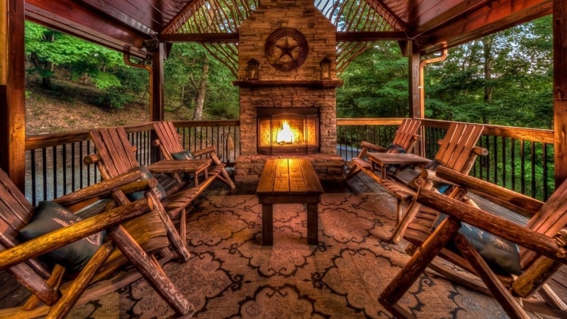Sectional Sofa in Cozy Cabin Living Room with Stone Fireplace and Log Walls