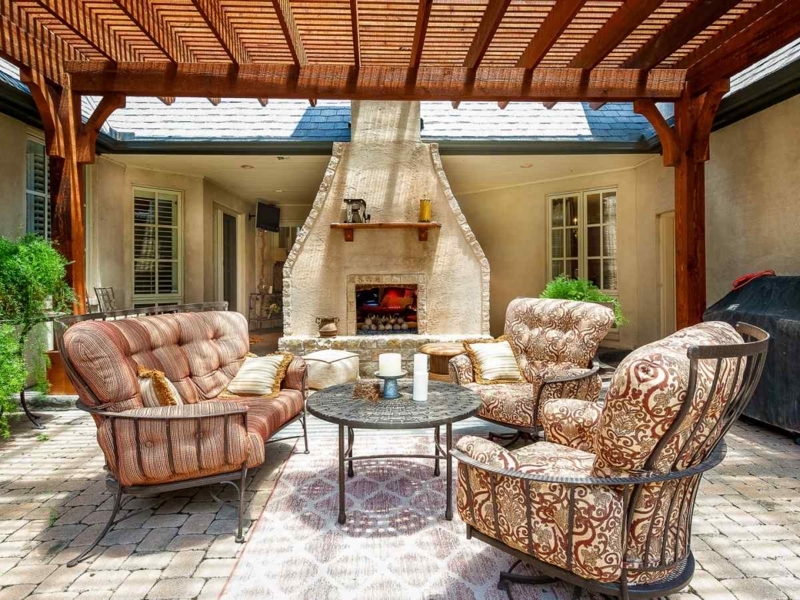 Stacked Stone Facade Fireplace with Raised Hearth in Garden Setting