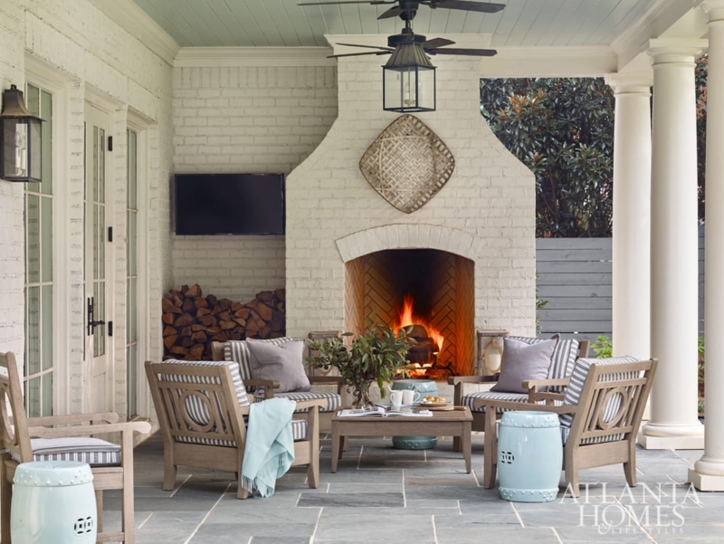 Stacked Stone Outdoor Fireplace on Luxury Patio with Exposed Beams