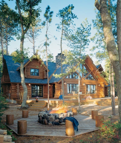 Stacked Stone Outdoor Fireplace with Built-In Wood Storage on Covered Patio