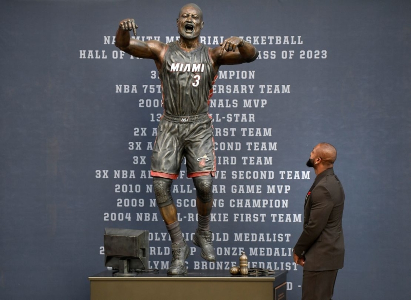 Stately Bronze Statue with Outstretched Arms in Stadium Plaza