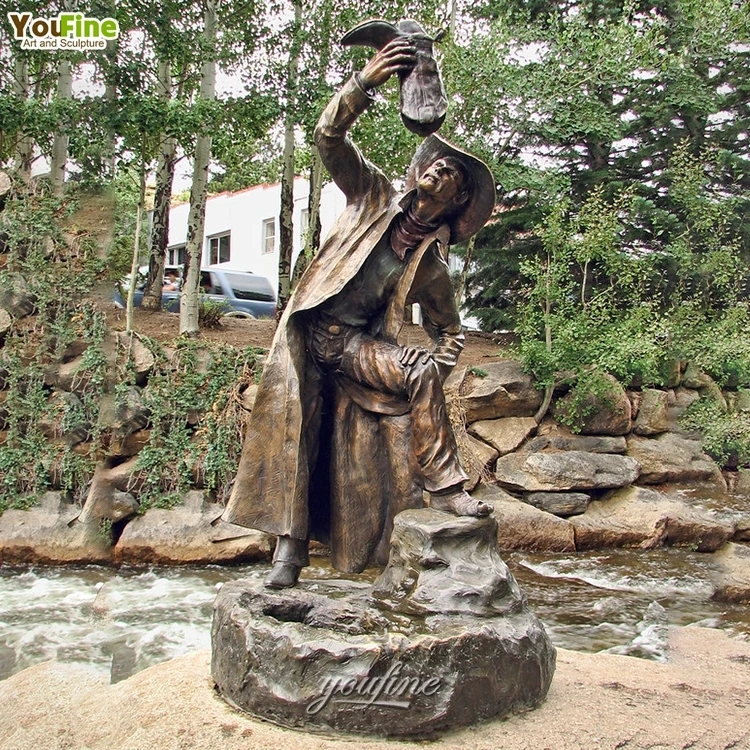 Statue with a cowboy theme in a drinking pose showing bronze casting.