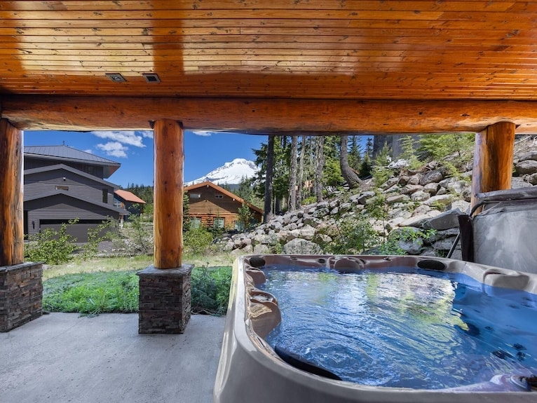 Stone-Clad Outdoor Fireplace on Rustic Lodge Deck with Mountain View