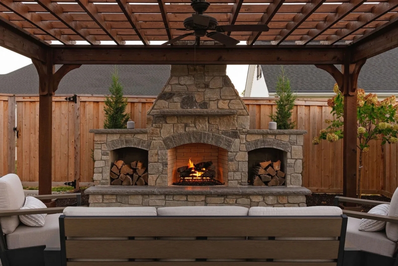 Stone Outdoor Fireplace with Integrated Wood Storage Niche