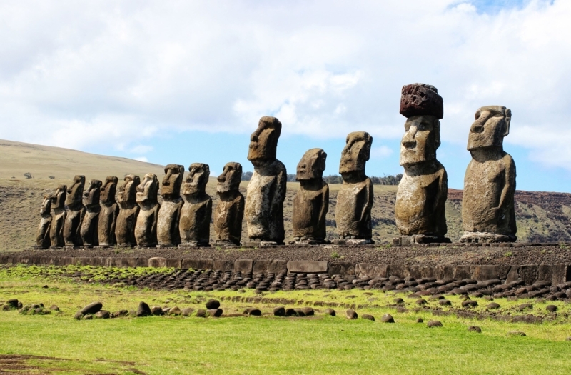 Stone Statue on Grassy Hillside with Weathered Surface Focal Points