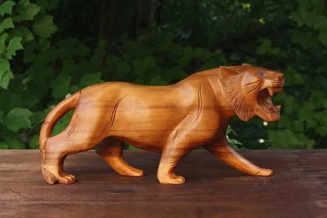 Tiger Sculpture in a prowling pose with hand carved wood texture.