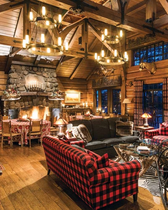 Timber Frame Sunroom with Stone Masonry Fireplace and Mountain Views